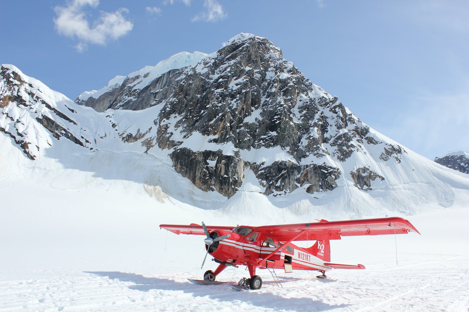 red monoplane in alps