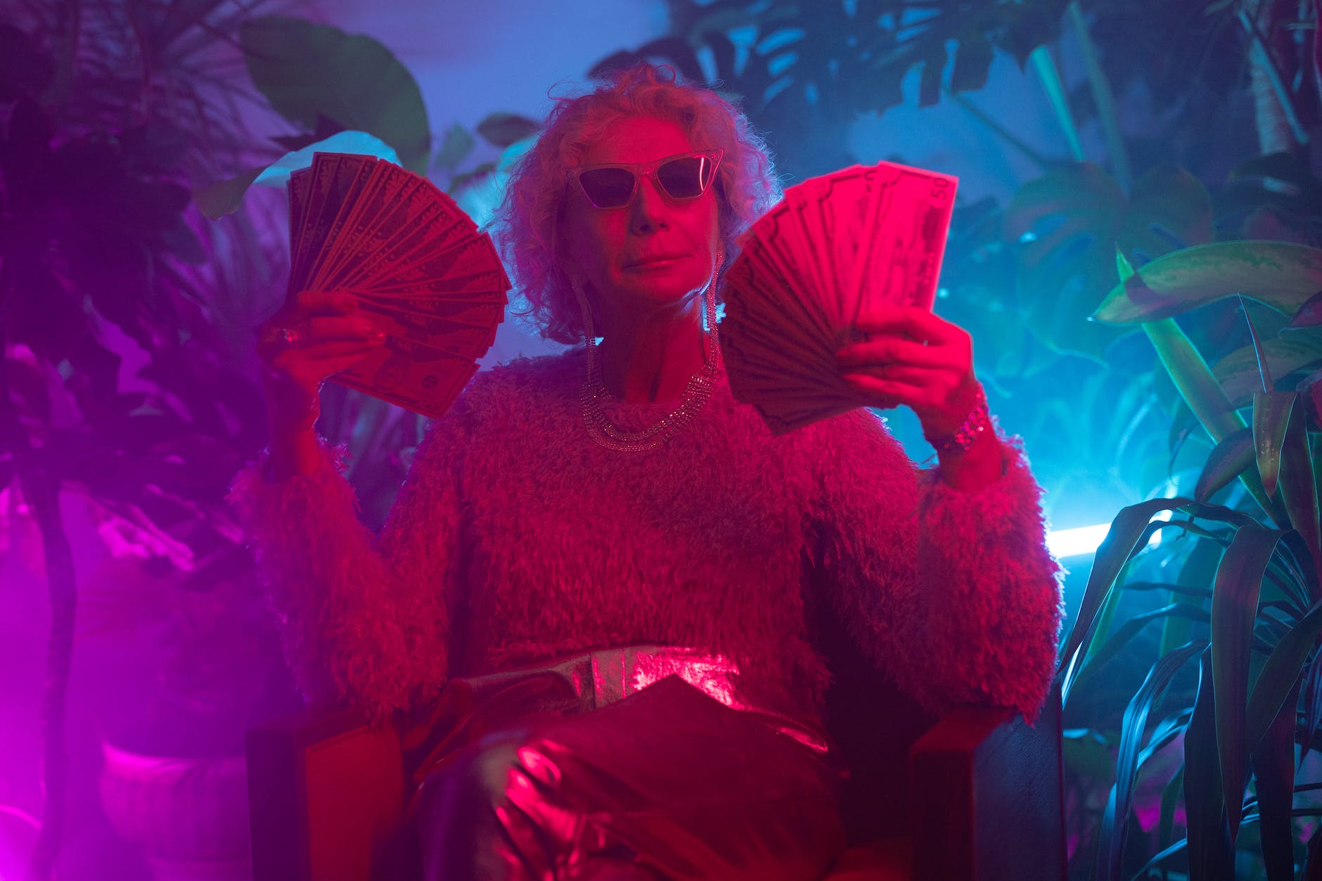 photo of an elderly woman holding money (Photo by Ron Lach)